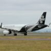 white and black airplane on brown field during daytime